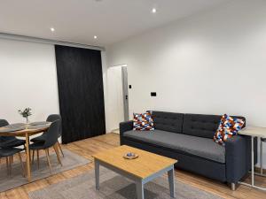 a living room with a couch and a table at Radnóti Apartman Győr in Győr