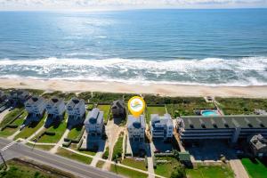 an aerial view of a resort with the beach at 8910 - Aquasition in Hatteras