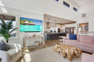 a living room with a couch and a kitchen at 8910 - Aquasition in Hatteras