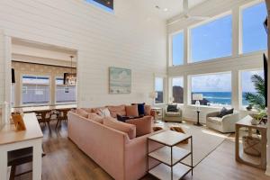 a living room with a couch and a table at 8910 - Aquasition in Hatteras