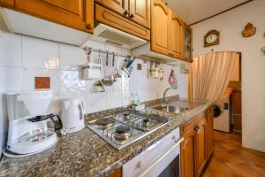 a small kitchen with a sink and a stove at House H-ELIOS in Lovran