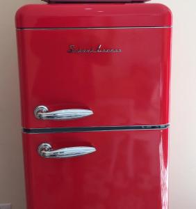 a red refrigerator with two silver handles on it at Luciano Valletta Studio - Self Catering in Valletta