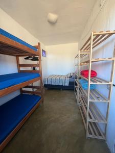 a room with three bunk beds in a room at Casa Iter Hostel & Base Trail in Lençóis
