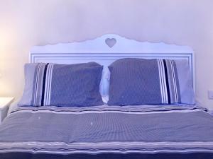 a bed with purple sheets and purple pillows at Luciano Valletta Studio - Self Catering in Valletta