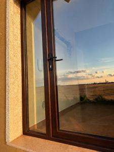 a window with a view of a field at Vila Matt in Vama Veche