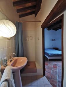 a bathroom with a sink and a shower with a bed at Maison de village, Verdon in Trigance +9 photos
