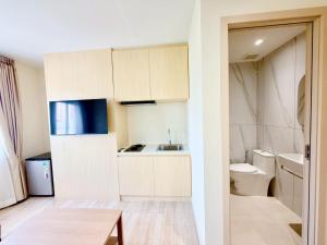 a small kitchen with a sink and a toilet at Le Hong Hotel Pratunam in Bangkok
