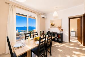 a dining room with a table and a view of the ocean at Villa Situla in Barbati