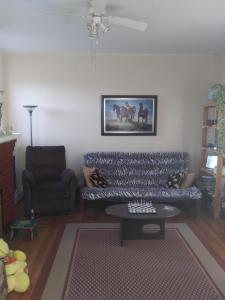 a living room with a couch and a table at Appartement centre ville de Campbellton NB in Campbellton