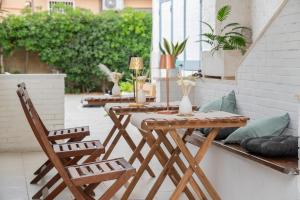 a wooden table and chairs on a patio at Annarè in Focene
