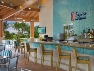 a bar in a restaurant with chairs and a counter at Hilton Orlando in Orlando