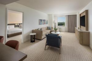 a hotel room with a couch and a bed at Hilton Orlando in Orlando