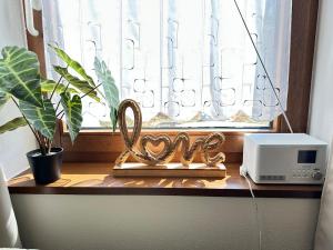 a window with a pretzel ornament on a window sill at Ferienwohnung mit Terrasse - Hunde willkommen in Falkenstein +27 photos
