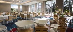a banquet hall with tables and chairs and windows at Hilton Orlando in Orlando +102 photos