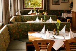 a restaurant with two tables with white napkins on them at Aparthotel Iris - inklusive Wildschönau Premium Card in Auffach