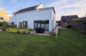 a white house with a lawn in front of it at Haus am Prekkesee in Xanten