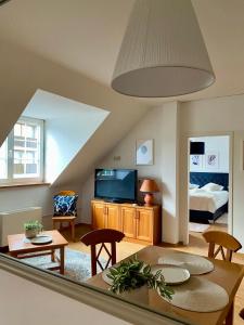 a living room with a table and a tv at Lake Veronika in Bled