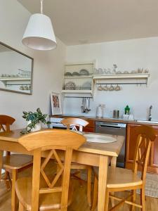 a kitchen with a wooden table and chairs at Lake Veronika in Bled +11 photos