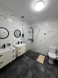 a bathroom with a toilet and a sink and mirror at AKT Residence in Agigea +29 photos