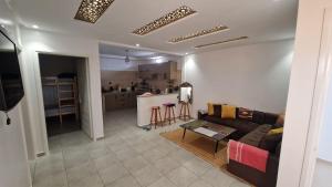 a living room with a couch and a kitchen at Hostel the little prince in Tarfaya +19 photos
