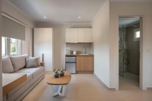 a living room with a couch and a table at AMARÉ suites in Nikiti