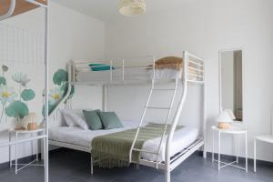 a bedroom with bunk beds with a ladder at Annarè in Focene
