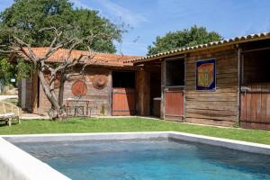 a swimming pool in front of a house at Le Grand Gîte in Vaison-la-Romaine
