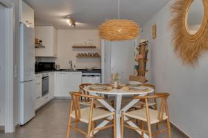 a kitchen with a table and chairs in a kitchen at Bon Dia Moraira in Moraira