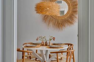 a dining room table with chairs and a mirror at Bon Dia Moraira in Moraira