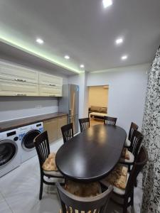 a kitchen with a table and chairs in a kitchen at Апартамент riverside in Yambol