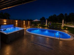 a swimming pool in a backyard at night at Oaza Gradiška in Bosanska Gradiška