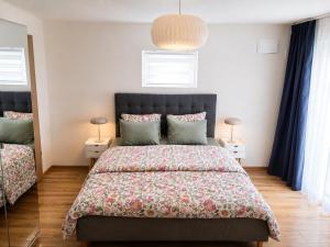 a bedroom with a large bed and two lamps at Oaza Gradiška in Bosanska Gradiška