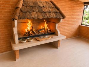 a fireplace in a brick wall with flames in it at Oaza Gradiška in Bosanska Gradiška