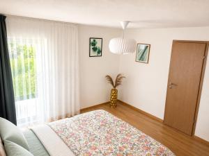 a bedroom with a bed and a potted plant at Oaza Gradiška in Bosanska Gradiška