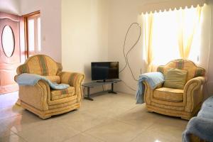 two chairs and a television in a living room at Good Times in Gingerland