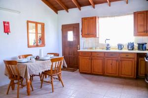 a kitchen with a table and chairs and a kitchen with a window at Good Times in Gingerland