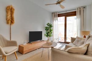 a living room with a couch and a tv at Bon Dia Moraira in Moraira