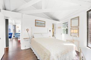 a white bedroom with a bed in a room at 8951 - Ozzie's Island Hideaway in Hatteras