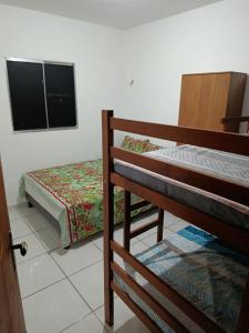 a bedroom with two bunk beds and a television at Jacumã Beach House in Conde +12 photos