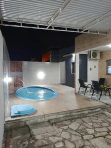 a large swimming pool with a fountain in a building at Jacumã Beach House in Conde