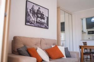 a living room with a couch and a picture on the wall at Vossa Bossa Olimpia in Olímpia