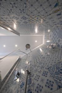 a bathroom with blue and white tiles on the ceiling at Grecale - stunning sea-view apartment with patio, up to 5 guests in Maiori +42 photos