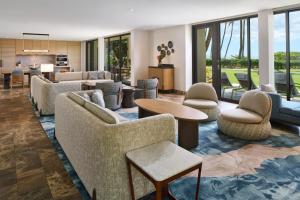 a living room with couches and tables and chairs at Andaz Maui at Wailea Resort - A Concept by Hyatt in Wailea