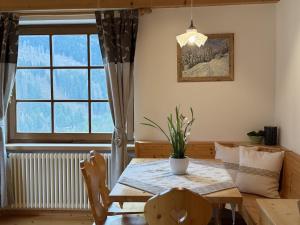 a dining room with a table and a window at Villetta Ximenes in Panchià