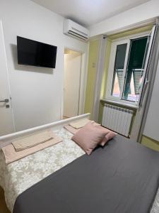 a bedroom with a bed with a flat screen tv on the wall at La terrazza in Varazze