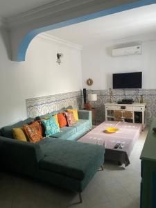 a living room with a couch and a table at SecretVilla in Ghār al Milḩ
