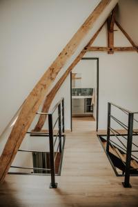 a staircase leading up to a loft with wooden beams at Le loft de Marthe in Bonnières