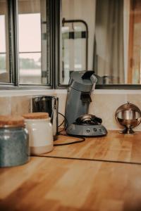 a kitchen counter with a coffee maker on a counter top at Le loft de Marthe in Bonnières