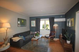 a living room with a couch and a table at Smia in Søgne