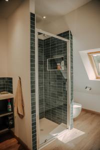 a bathroom with a shower with a glass door at Le loft de Marthe in Bonnières